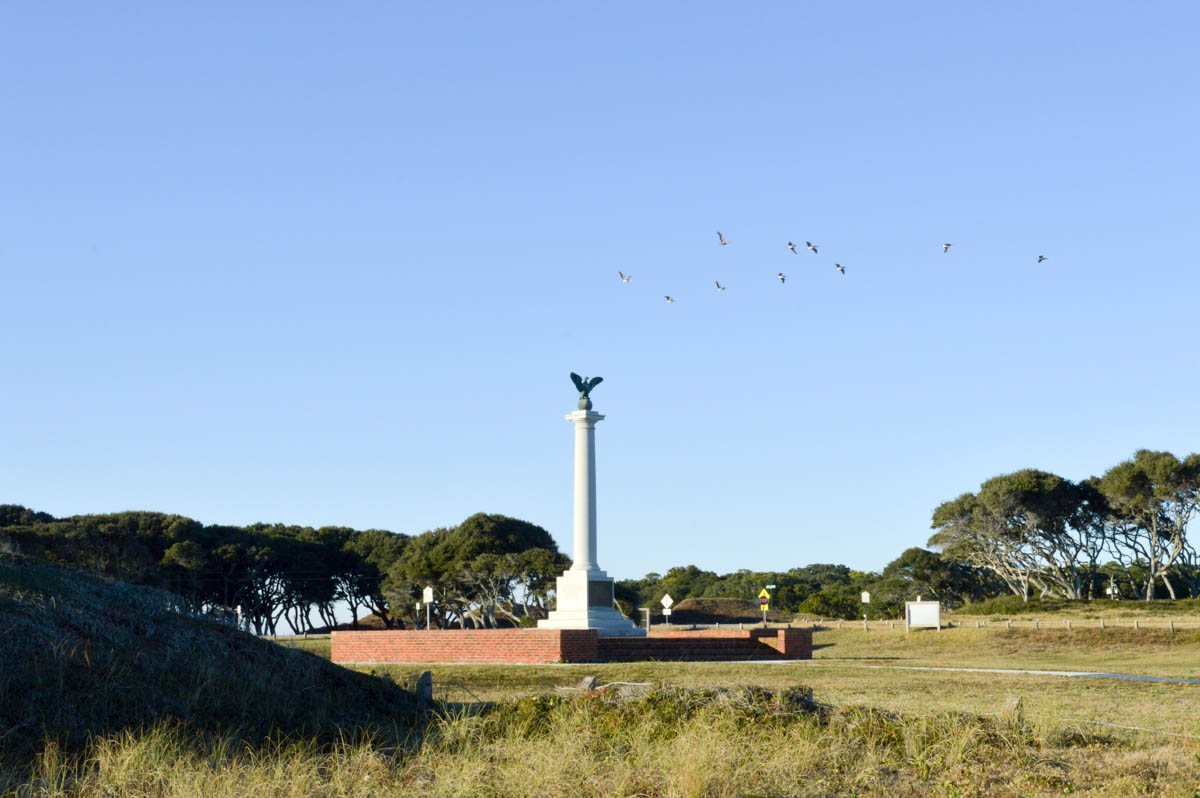 More pelicans flying over the Confederate Memorial at the fort. Conferate Memorials are common sight in North Carolina